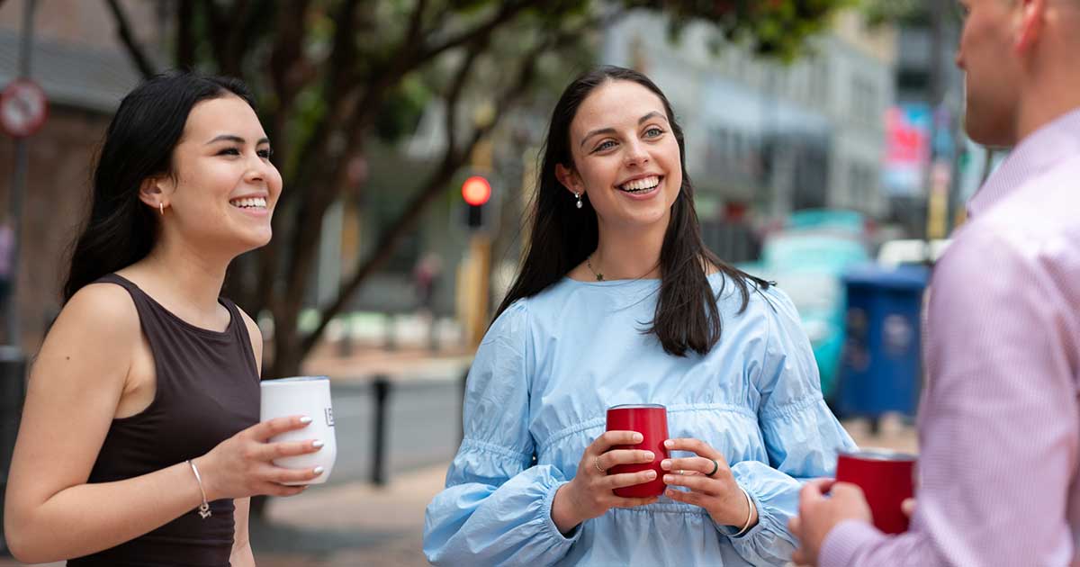 Young professionals standing and having coffee