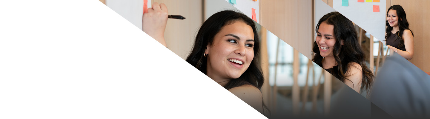 young professional female smiling writing on whiteboard