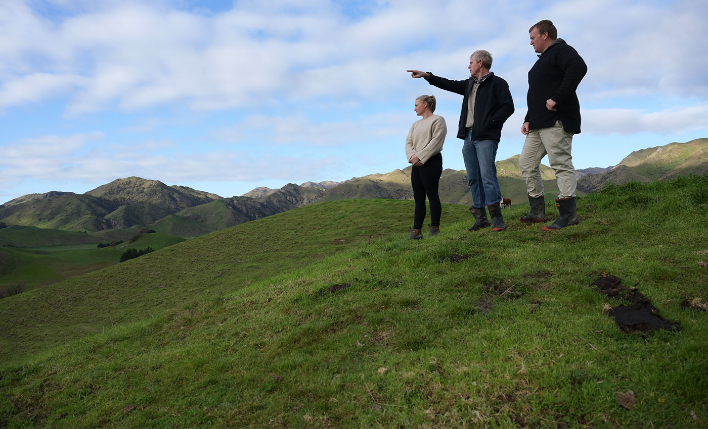 3 people standing on farm hill