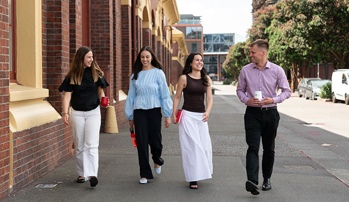 Group of students walking and smiling