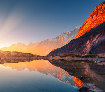 sunrise over water and mountains